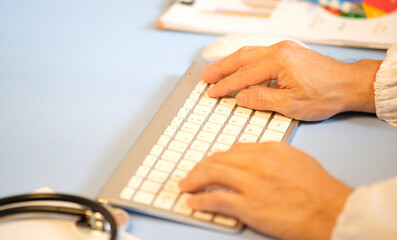 Poster - Close-up of a doctor wearing a uniform taking notes, a physician, therapist, or practitioner filling out medical paperwork and writing a prescription for a patient. Concept of health care and medicine