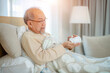 © visoot - Senior man taking medicine at home,Medicine, Health care and people concept.