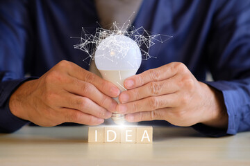 Poster - Innovation. Concept new idea concept with innovation and inspiration, innovative technology in science and communication concept, hands holding light bulb.