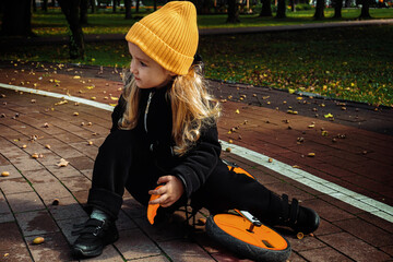 Cutie little girl rides on bicycle at the park