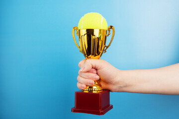 Wall Mural - tennis trophy, winner award cup in the hand