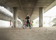 © Marko - Young urban woman with freestyle bike