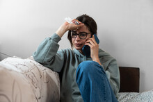 Young Business Woman Calling On Smartphone To Her Work To Say That She Is Sick And She Cant Go To Work. Frustrated Female Feeling Ill And Have High Body Temperature Talking With Her Boyfriend.