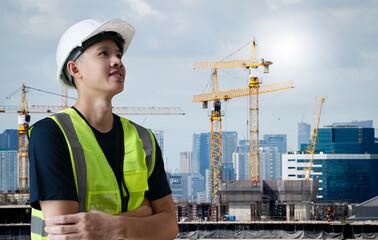 Wall Mural - Asian civil engineer or architecture,professional worker man wearing white hat looking forward to success,young adult man working at construction site ,Concept work in success.