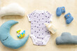 Baby cotton bodysuit with toys flat lay, top view