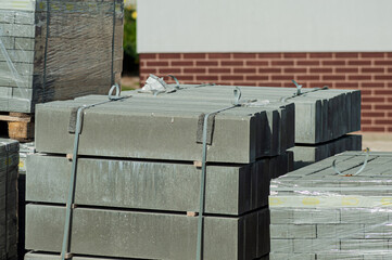 Wall Mural - Blocks of building tiles of gray color are on the street. Theme of building construction.