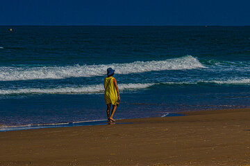 Wall Mural - woman walking on the beach