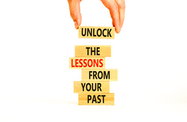 Wall Mural - Lessons from your past symbol. Concept words Unlock the lessons from your past on wooden blocks. Bussinesman hand. Beautiful white background. Business and lessons from your past concept. Copy space.