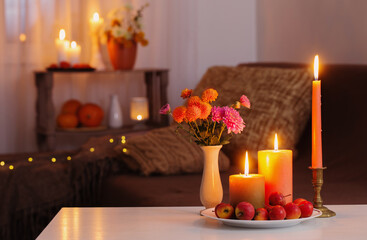 Wall Mural - autumn decorations with burning candles at home