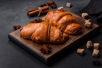 Fresh crisp chocolate croissants on wooden cutting board