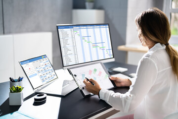 Poster - Employee Working On Calendar Schedule