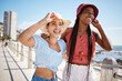 © Siphosethu F/peopleimages.com - Summer, fashion and gen z girl friends in the city near the beach or ocean for holiday, vacation or youth wellness. Vitamin d, happiness and love with young women wearing hat outdoor in the sunshine