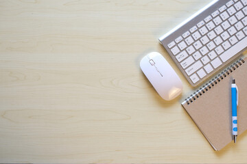 Poster - Blank notebook with pen are on top of computer keyboard over white office desk table with office supplies. Calculator and pen on paper, Flat lay top view office desk working space 