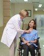 Doctor talk with patient sitting in wheelchair