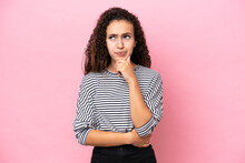 Young Hispanic Woman Isolated On Pink Background Having Doubts And Thinking