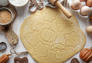 Wall Mural - Baking cookies in the form of pumpkin and leaves