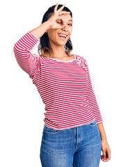 Sticker - Young woman wearing casual clothes smiling happy doing ok sign with hand on eye looking through fingers