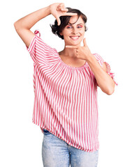 Poster - Beautiful young woman with short hair wearing casual summer clothes smiling making frame with hands and fingers with happy face. creativity and photography concept.