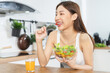 Diet, Dieting happy pretty asian young woman, girl hand using fork at tomato on mix vegetables, green salad bowl, eat  food is low fat good health. Nutritionist female, Weight loss for healthy person.