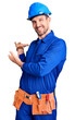 © Krakenimages.com - Young handsome man wearing worker uniform and hardhat doing frame using hands palms and fingers, camera perspective