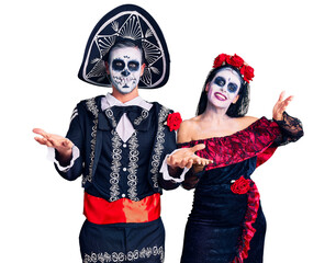 Poster - Young couple wearing mexican day of the dead costume over background smiling cheerful offering hands giving assistance and acceptance.