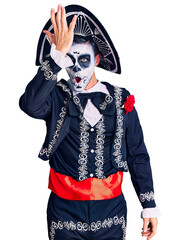 Sticker - Young man wearing day of the dead costume over background surprised with hand on head for mistake, remember error. forgot, bad memory concept.