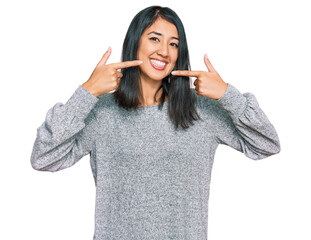 Beautiful asian young woman wearing casual clothes smiling cheerful showing and pointing with fingers teeth and mouth. dental health concept.