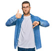 © Krakenimages.com - Young caucasian man wearing casual clothes doing thumbs up and down, disagreement and agreement expression. crazy conflict
