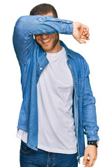 Poster - Young caucasian man wearing casual clothes covering eyes with arm smiling cheerful and funny. blind concept.