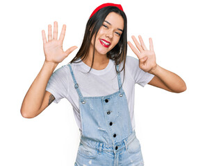 Poster - Young hispanic girl wearing casual clothes showing and pointing up with fingers number nine while smiling confident and happy.