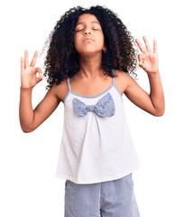 African american child with curly hair wearing casual clothes relax and smiling with eyes closed doing meditation gesture with fingers. yoga concept.