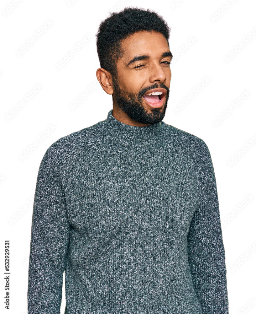 Young african american man wearing casual clothes winking looking at the camera with sexy expression, cheerful and happy face.