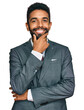 © Krakenimages.com - Young african american man wearing business clothes looking confident at the camera smiling with crossed arms and hand raised on chin. thinking positive.