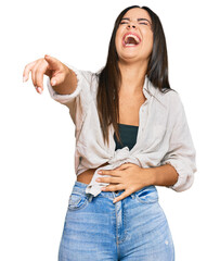 Wall Mural - Young beautiful hispanic girl wearing casual clothes laughing at you, pointing finger to the camera with hand over body, shame expression