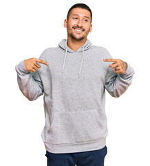 Sticker - Handsome man with tattoos wearing casual sweatshirt looking confident with smile on face, pointing oneself with fingers proud and happy.