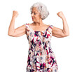 © Krakenimages.com - Senior grey-haired woman wearing casual clothes showing arms muscles smiling proud. fitness concept.