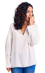 Wall Mural - Middle age beautiful woman wearing casual sweater looking stressed and nervous with hands on mouth biting nails. anxiety problem.