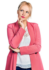 Canvas Print - Young blonde woman wearing business clothes serious face thinking about question with hand on chin, thoughtful about confusing idea