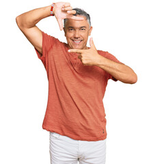 Canvas Print - Handsome middle age man wearing casual clothes smiling making frame with hands and fingers with happy face. creativity and photography concept.