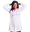 © Krakenimages.com - Young african american woman wearing doctor stethoscope relaxing and stretching, arms and hands behind head and neck smiling happy