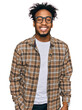 Young african american man with beard wearing casual clothes and glasses with a happy and cool smile on face. lucky person.