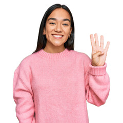 Poster - Young asian woman wearing casual winter sweater showing and pointing up with fingers number four while smiling confident and happy.