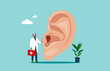 The physician, specialist holds a big sign - human ear. Ear doctor.  Flat vector illustration.