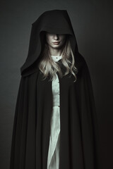 Mysterious hooded dark woman