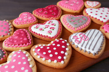 Wall Mural - Rows of gorgeous heart shaped with beautiful pattern cookies on wooden breadboard