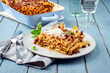Leinwandbild Motiv Traditional Italian candele alla marcinata pasta with miced meat and parmesan cheese served as close-up on a classic white plate