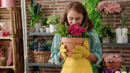 Sticker - Young beautiful hispanic woman florist smelling plant at florist