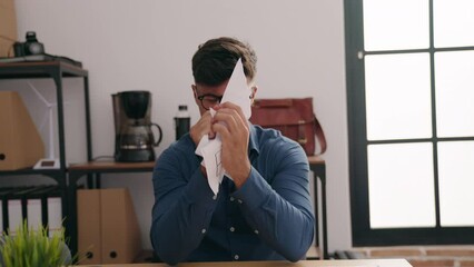 Sticker - Young hispanic man business worker furious breaking document at office