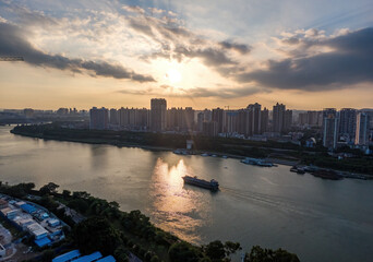 Wall Mural - The city riverside architectural landscape and the sand ship passing by in the evening