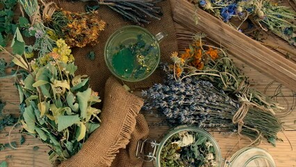 Wall Mural - Grandmother makes tea with medicinal herbs. Selective focus.